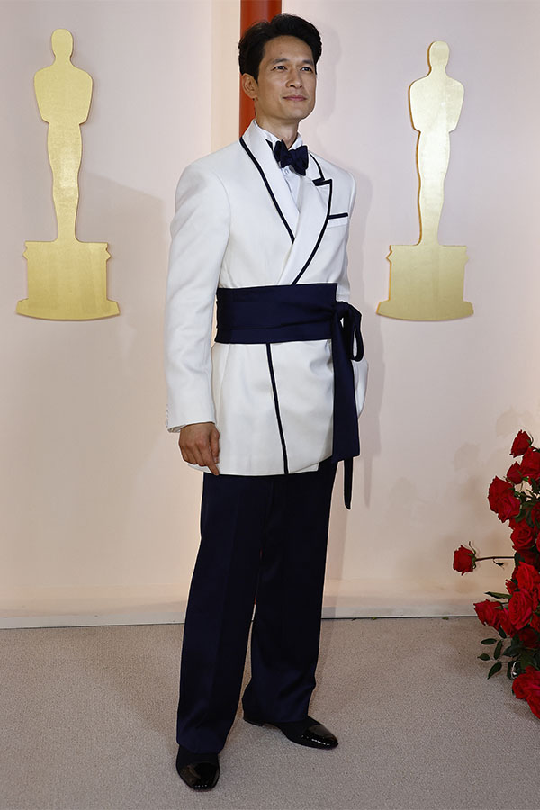 Harry Shum Jr. poses on the champagne-colored red carpet during the Oscars arrivals at the 95th Academy Awards in Hollywood, Los Angeles, California, U.S., March 12, 2023. REUTERS/Eric Gaillard