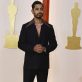 Riz Ahmed poses on the champagne-colored red carpet during the Oscars arrivals at the 95th Academy Awards in Hollywood, Los Angeles, California, U.S., March 12, 2023. REUTERS/Eric Gaillard
