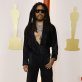 Lenny Kravitz poses on the champagne-colored red carpet during the Oscars arrivals at the 95th Academy Awards in Hollywood, Los Angeles, California, U.S., March 12, 2023. REUTERS/Eric Gaillard